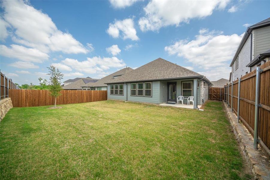 Back of property with a patio and a yard