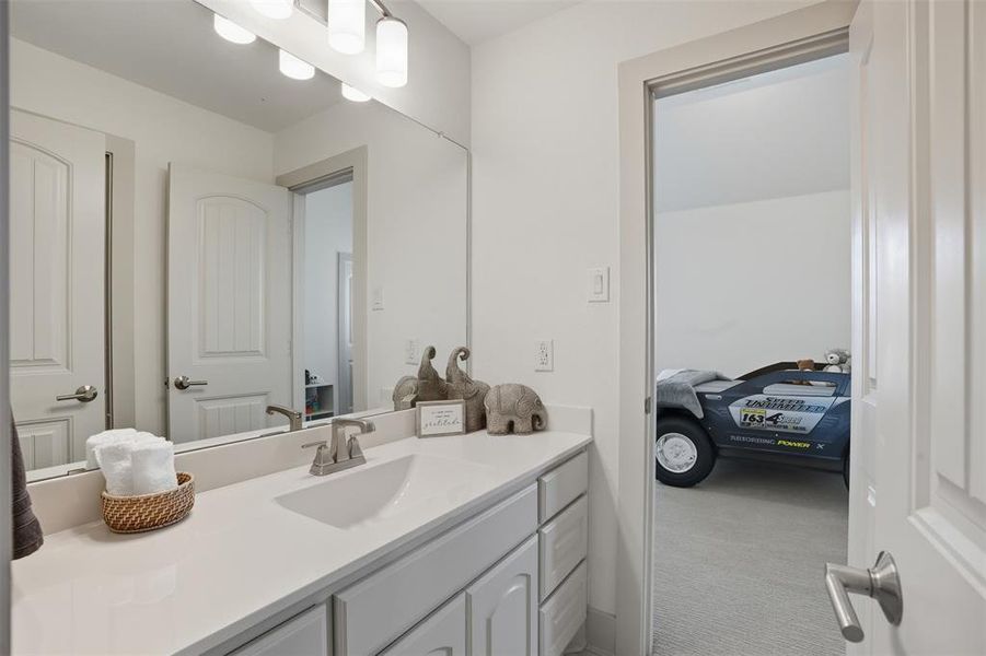 Bathroom with vanity and light colored carpet Bathroom with vanity and light colored carpet