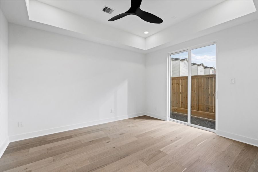 Wrapped in natural light and grounded by warm-toned floors, this flexible first-floor room invites calm focus or effortless hospitality. With direct access to the private yard, it seamlessly blends indoor comfort with outdoor ease—ideal as a dedicated workspace, creative studio, or welcoming guest suite.