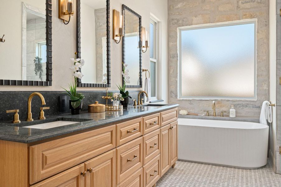 Full bath with double vanity and a soaking tub