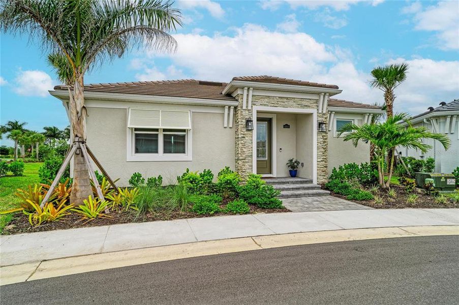 Front exterior of a new home in Esplanade at Azario Lakewood Ranch, Lakewood Ranch, FL, highlighting curb appeal (Image 2). Front exterior of a new home in Esplanade at Azario Lakewood Ranch, Lakewood Ranch, FL, highlighting curb appeal (Image 2).