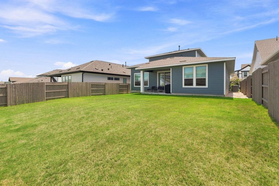 Rear exterior view of the two-story home highlighting the covered patio, horizontal siding, and clean rooflines. Rear exterior view of the two-story home highlighting the covered patio, horizontal siding, and clean rooflines.