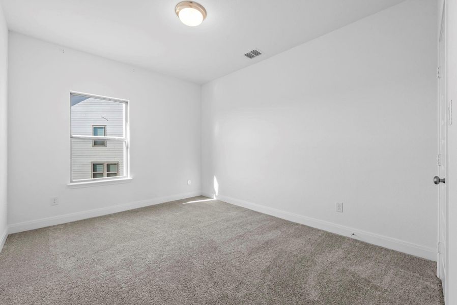Empty room with carpet flooring and baseboards