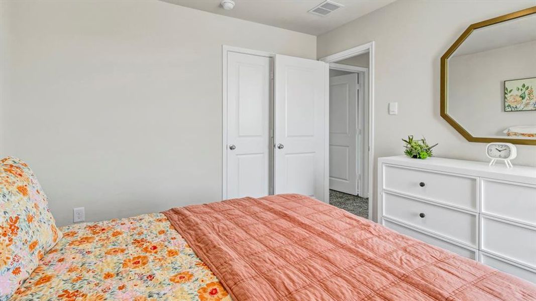 Bedroom featuring light gray walls, white trim, and gray carpet Bedroom featuring light gray walls, white trim, and gray carpet