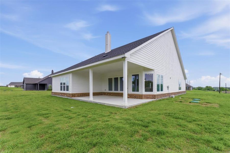 The property features a white exterior with a dark roof and a covered patio