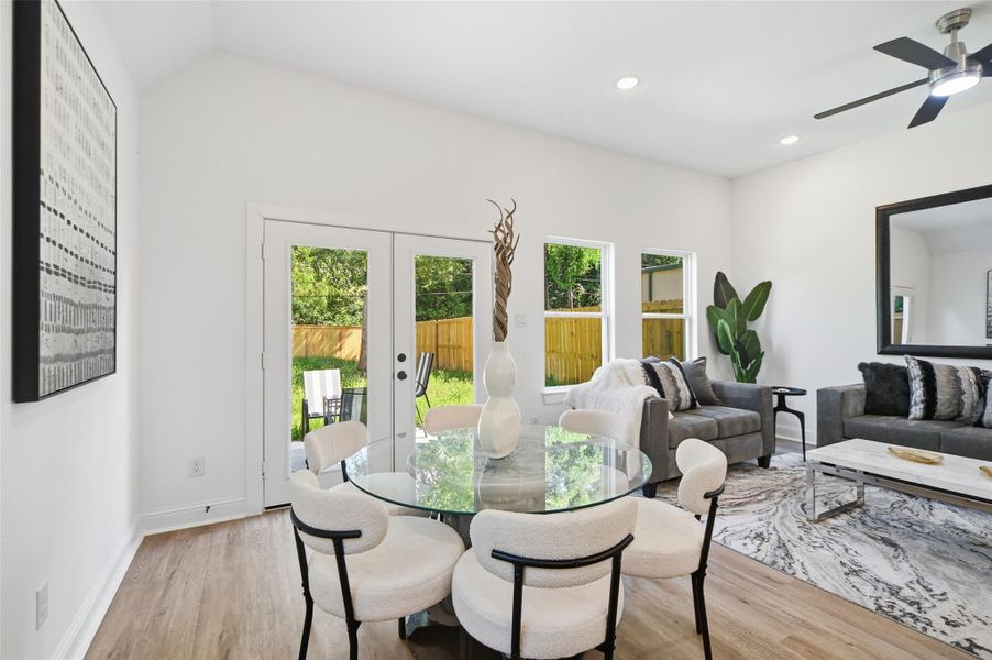 Open concept kitchen, dining and living room, with lots of natural light.
