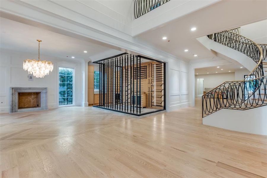 Wine room featuring a chandelier and crown molding