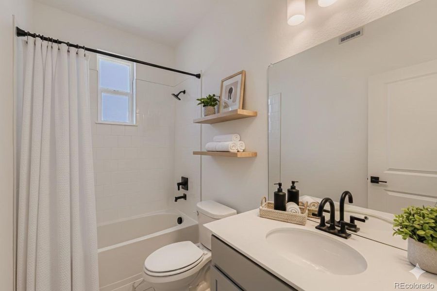Secondary Bathroom with Tub. Staged