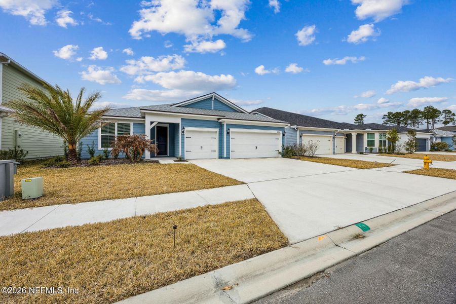 Front exterior of a new home in Wingate Landing, Jacksonville, FL, highlighting curb appeal (Image 26).