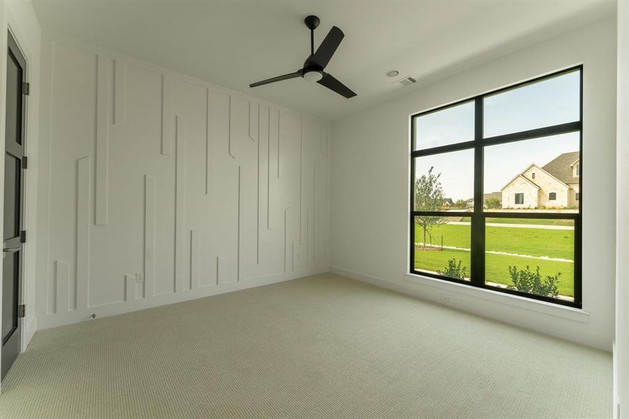 Carpeted empty room featuring ceiling fan Carpeted empty room featuring ceiling fan