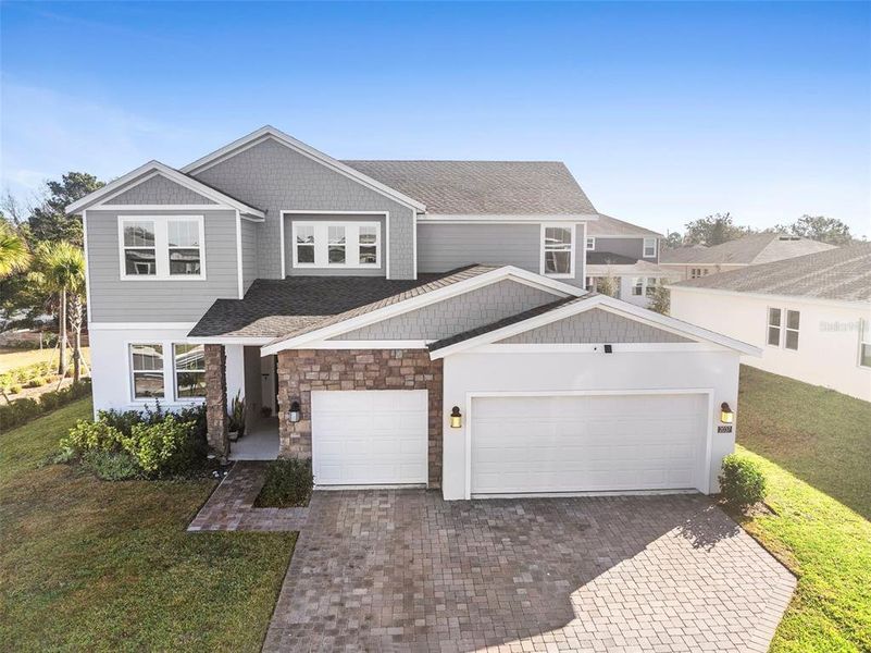 Front exterior of a new home in Rhett's Ridge: Legacy Collection, Apopka, FL, highlighting curb appeal (Image 23).