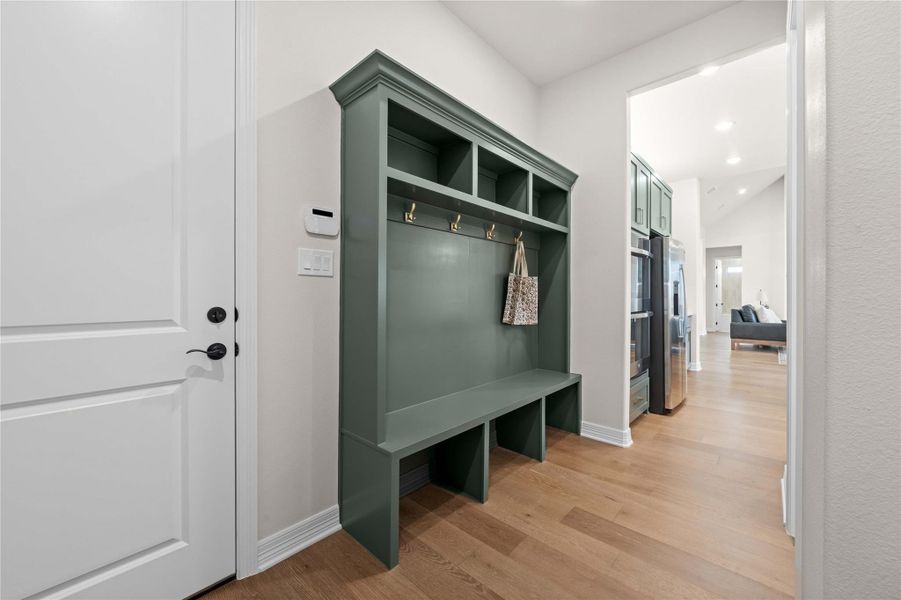 A well-appointed mudroom offers functional storage and organization with built-in shelving. A well-appointed mudroom offers functional storage and organization with built-in shelving.