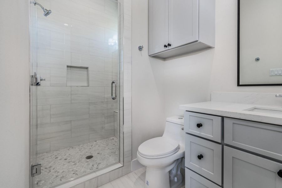 The ensuite bathroom includes a standing shower and plenty of storage space. The ensuite bathroom includes a standing shower and plenty of storage space.