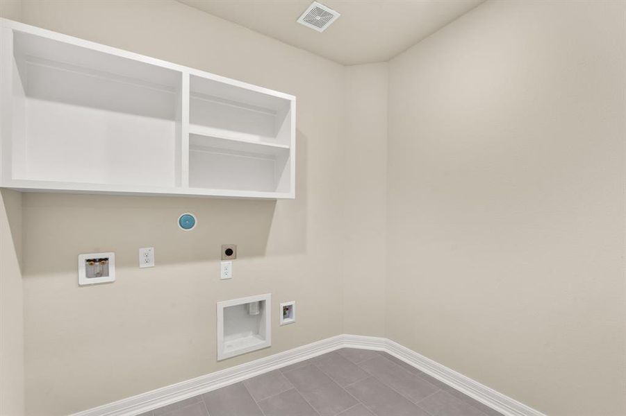 The laundry room layout is carefully planned for optimal workflow with designated areas for washing, drying, and storing.