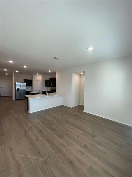 Kitchen featuring sink, a center island, light hardwood / wood-style flooring, appliances with stainless steel finishes, and kitchen peninsula