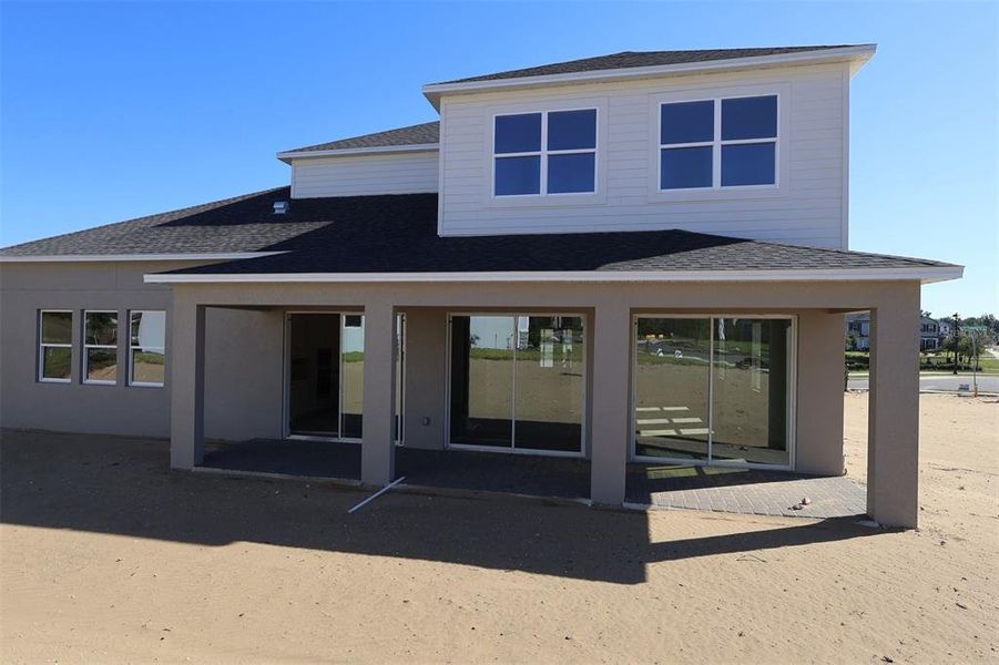 Front exterior of a new home in Emerson Pointe, Apopka, FL, highlighting curb appeal (Image 2). Front exterior of a new home in Emerson Pointe, Apopka, FL, highlighting curb appeal (Image 2).