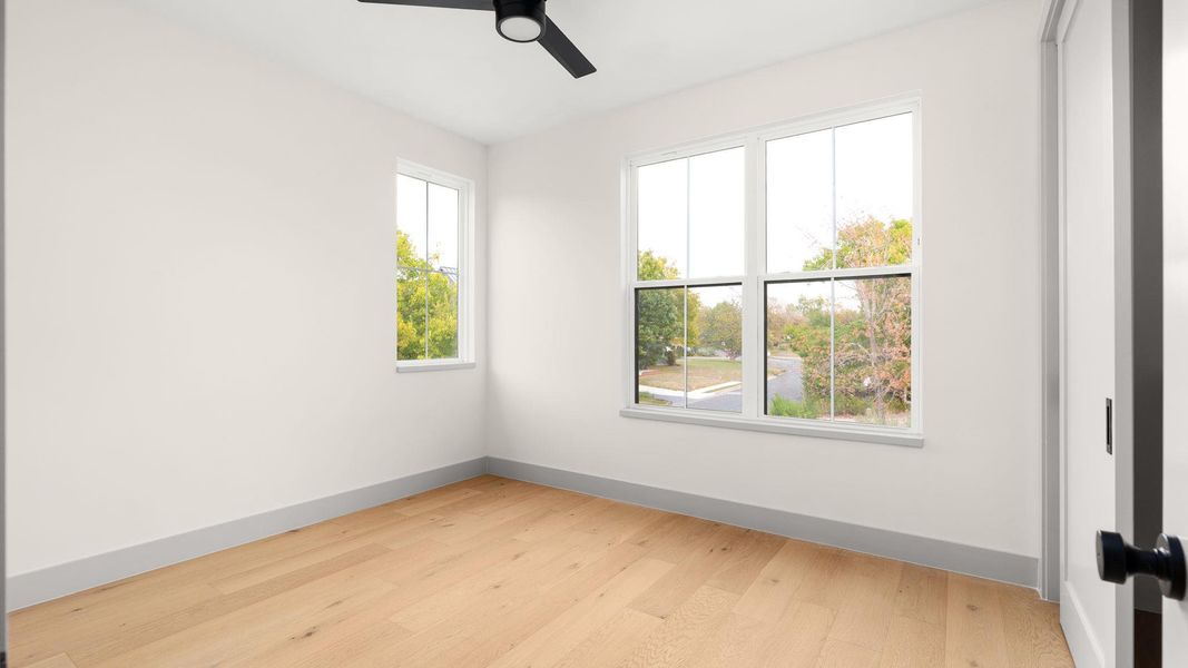Unfurnished room with light wood-type flooring and ceiling fan