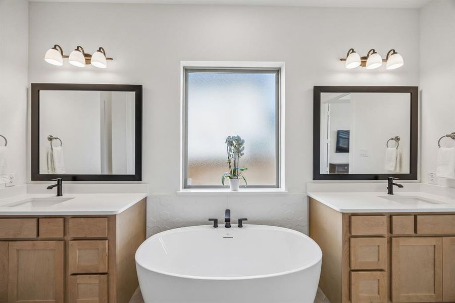 Full bath with a soaking tub and two vanities