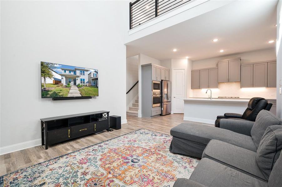 Staircase with horizontal iron banister just off the main living area leads to 2nd floor living space.