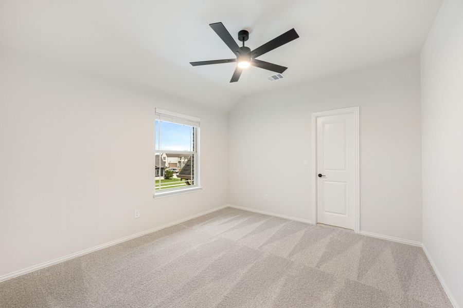 Empty bedroom with gray carpet, white walls, ceiling fan, and single window Empty bedroom with gray carpet, white walls, ceiling fan, and single window