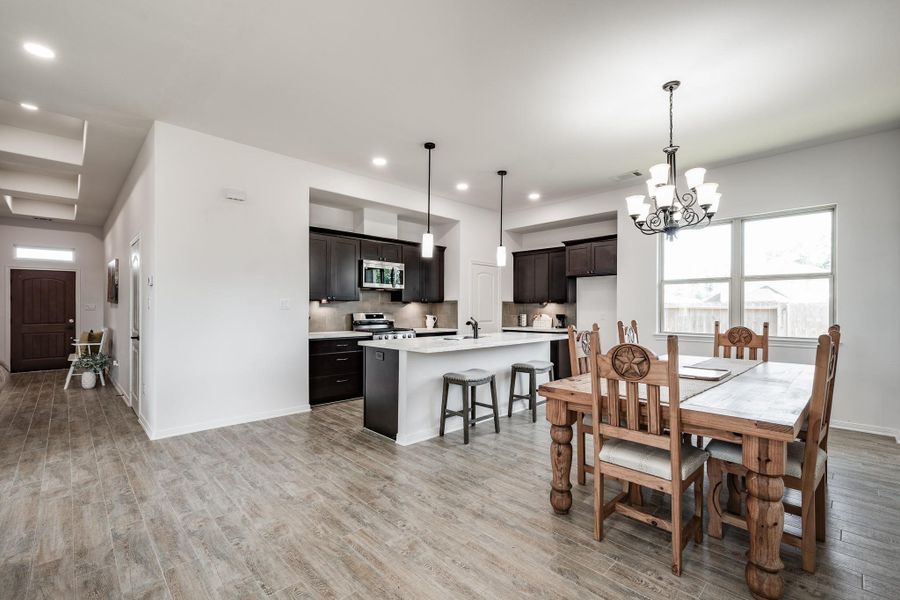 Additional view showcasing natural light and seamless flow to dining.