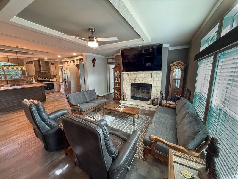 living room with fireplace and big screen TV which conveys.