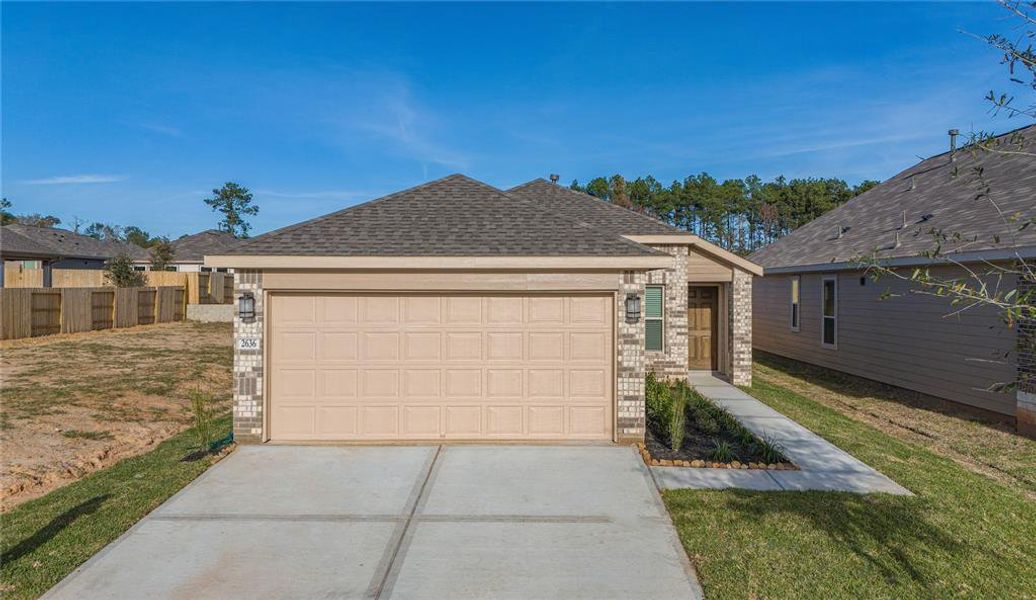 Aerial view of the home showcasing the lush landscaping and ample side yard space.