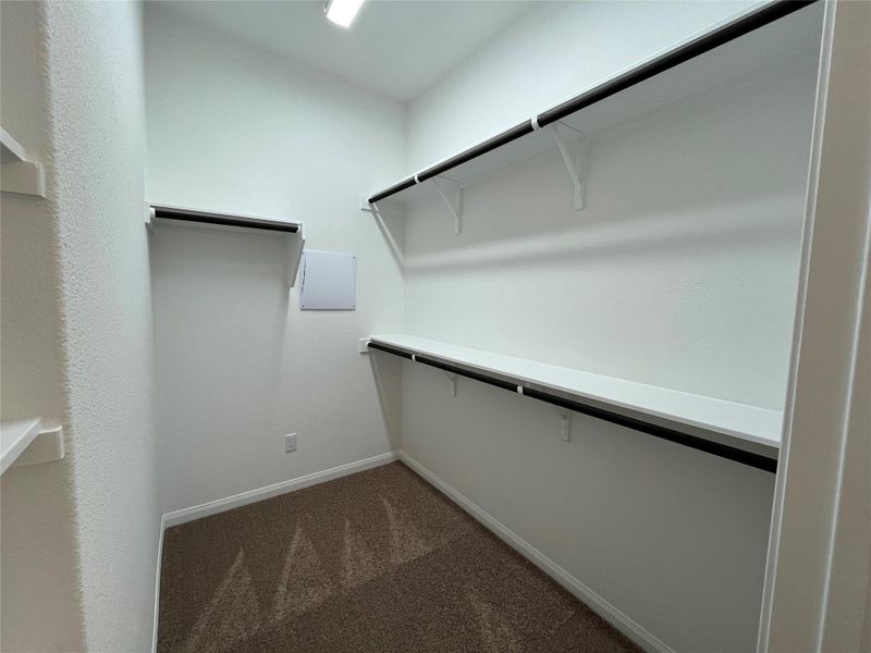 Spacious master closet featuring