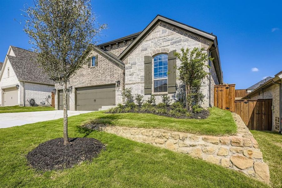 Front exterior of a new home in Reunion 60s, Rhome, TX, highlighting curb appeal (Image 1). Front exterior of a new home in Reunion 60s, Rhome, TX, highlighting curb appeal (Image 1).