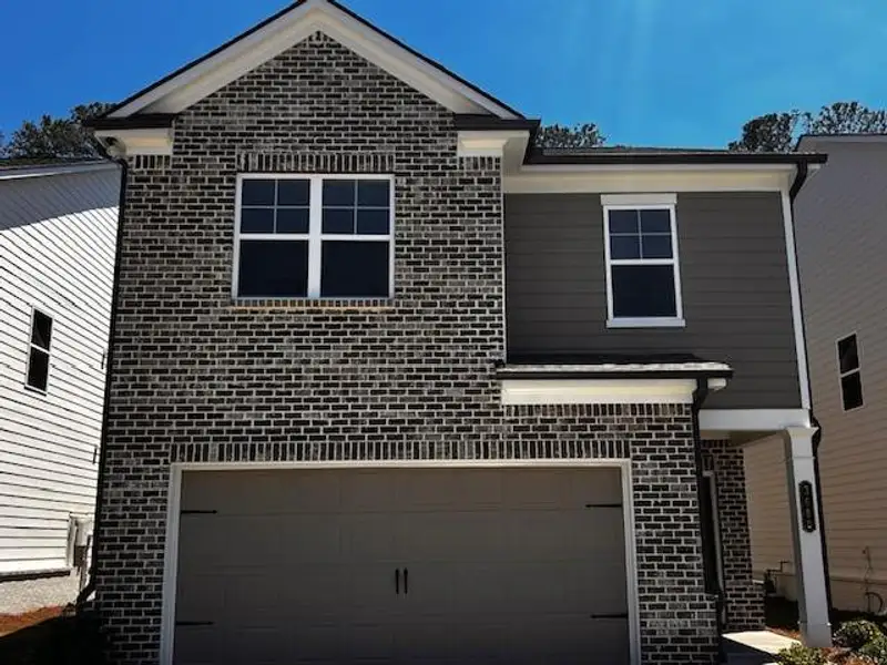 Front exterior of a new home in Crofton Place Enclave, Snellville, GA, highlighting curb appeal (Image 1). Front exterior of a new home in Crofton Place Enclave, Snellville, GA, highlighting curb appeal (Image 1).