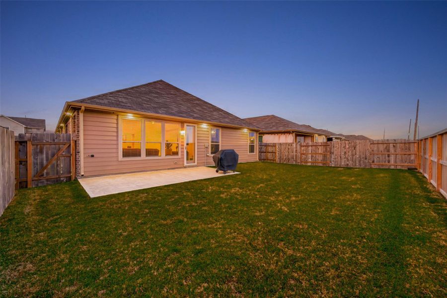 Exterior showcases elegant recessed lighting throughout, creating a warm, inviting glow and standout curb appeal after sunset