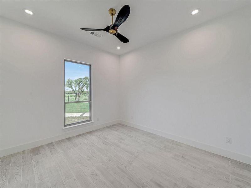 Empty room with recessed lighting, light wood-type flooring, and ceiling fan