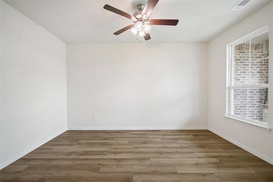 Unfurnished room with wood finished floors and ceiling fan