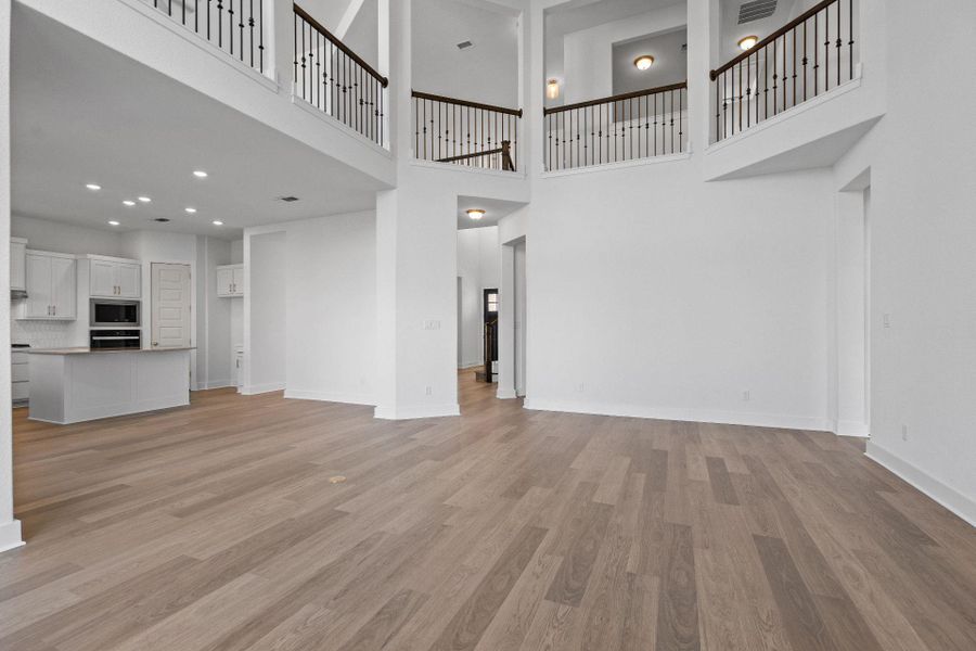 Family Room with soaring ceiling & fireplace