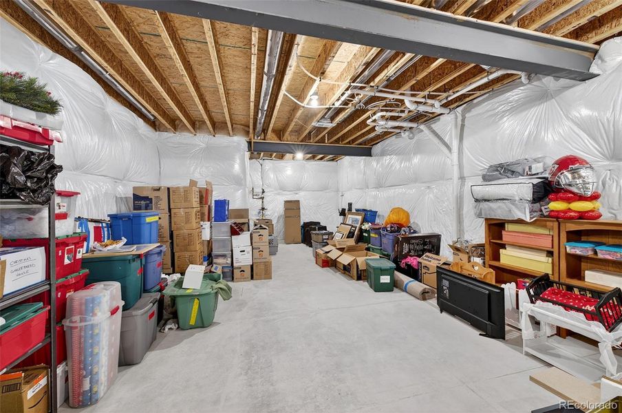 Basement Storage / Utility Area – Large unfinished storage area offering ample space for seasonal décor, equipment, or future expansion.