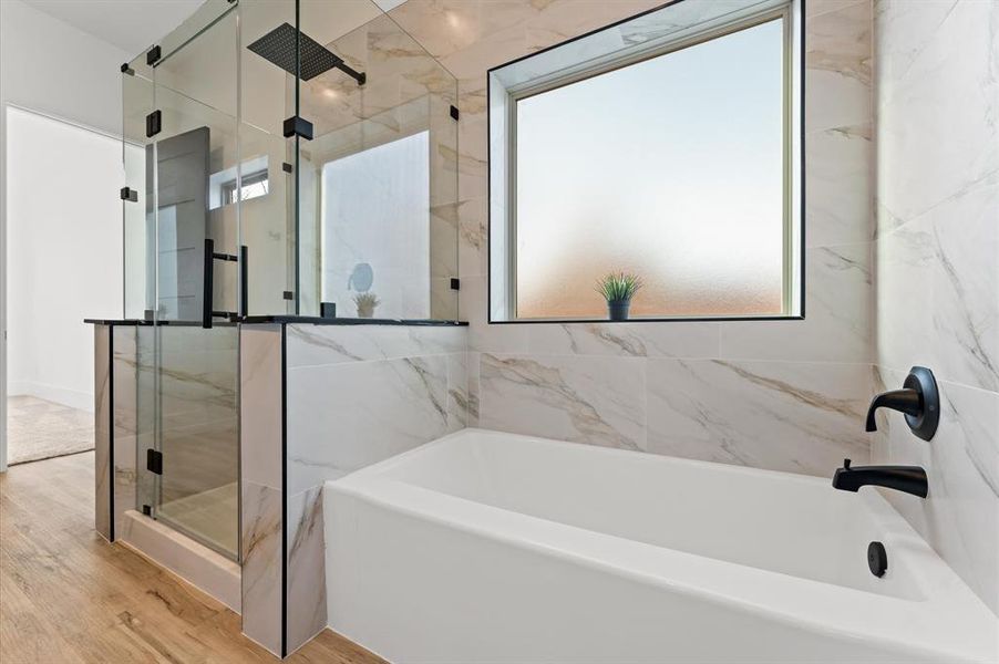 Primary bathroom with sleek modern finishes, a spacious layout, and high-end details create a spa-like retreat.