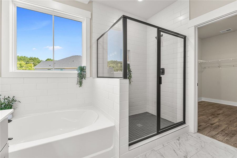 This spacious bathroom offers a relaxing soaking t
