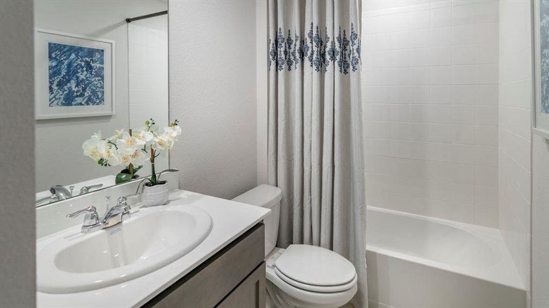 Bathroom with shower / bath combination with curtain and vanity Bathroom with shower / bath combination with curtain and vanity