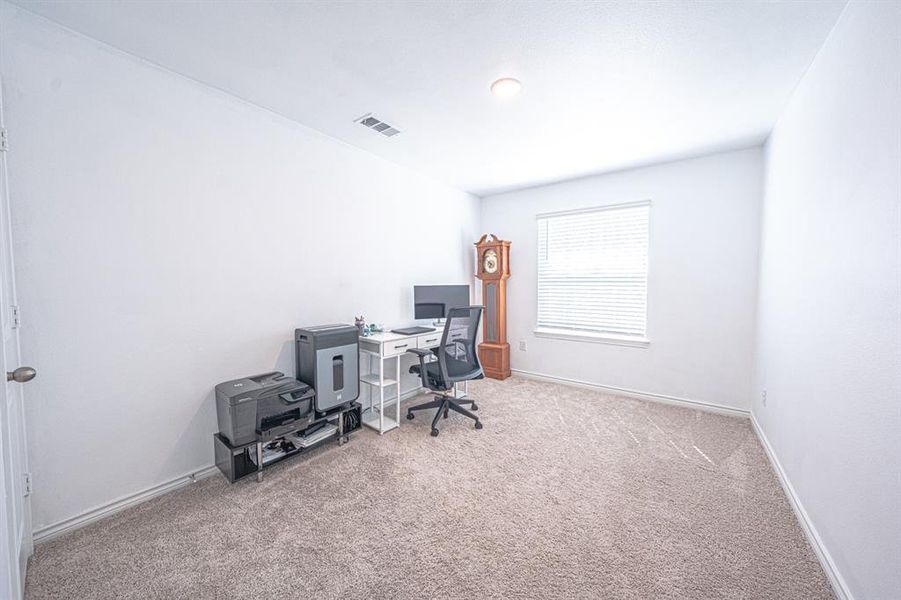 Office with light carpet and baseboards