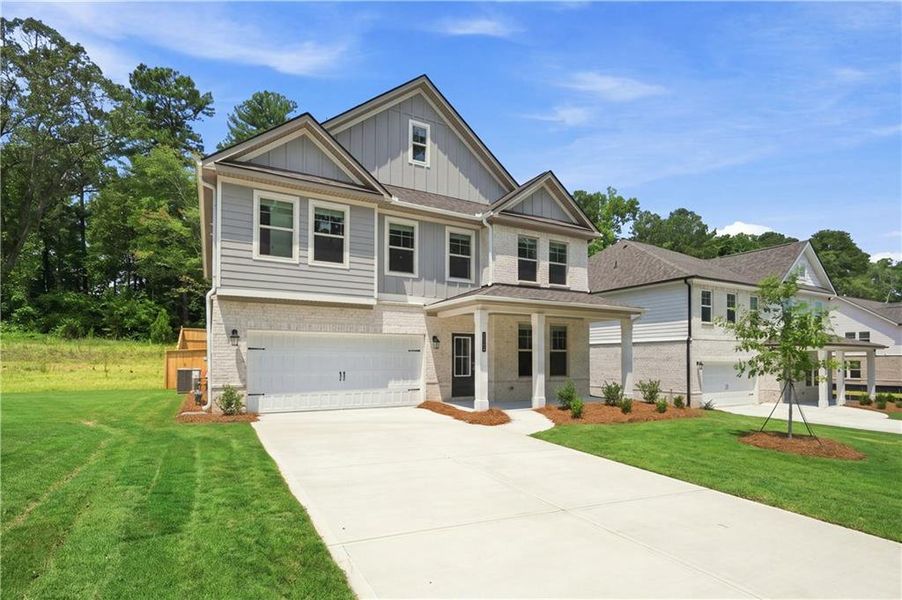 Front exterior of a new home in Hamilton Lakes, Lawrenceville, GA, highlighting curb appeal (Image 17).