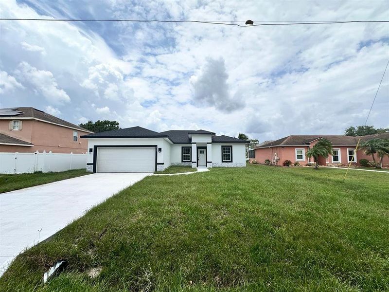 Front exterior of a new home in , Poinciana, FL, highlighting curb appeal (Image 18). Front exterior of a new home in , Poinciana, FL, highlighting curb appeal (Image 18).