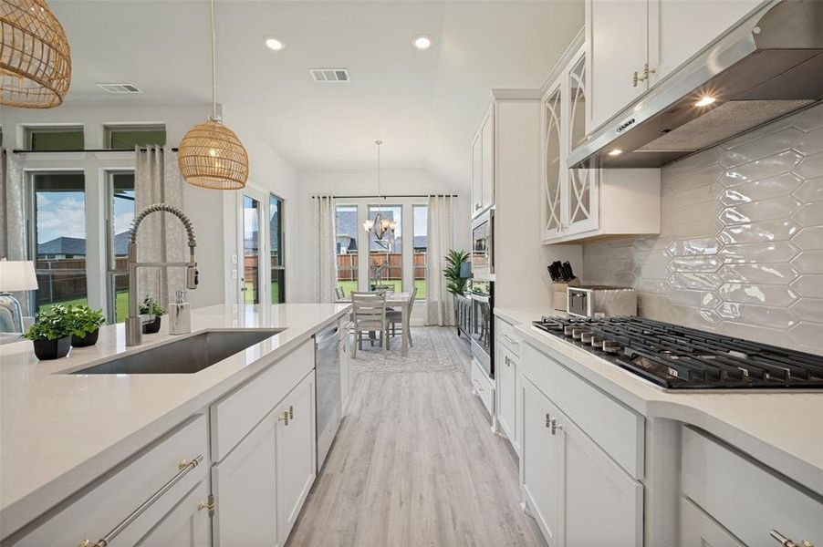 Designed with both beauty and functionality in mind, this gourmet kitchen showcases an oversized quartz island, double ovens, stainless steel appliances, designer lighting, and extensive cabinetry. The open-concept layout creates a seamless flow for entertaining while providing a sophisticated space for everyday living Designed with both beauty and functionality in mind, this gourmet kitchen showcases an oversized quartz island, double ovens, stainless steel appliances, designer lighting, and extensive cabinetry. The open-concept layout creates a seamless flow for entertaining while providing a sophisticated space for everyday living