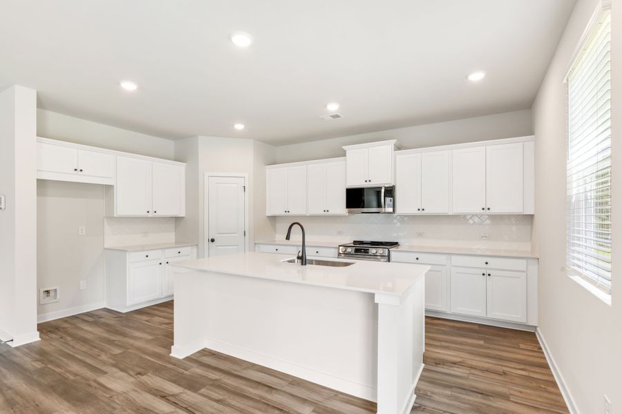 A kitchen with white cabinets. A kitchen with white cabinets.