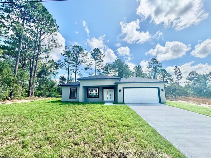 Front exterior of a new home in , Citrus Springs, FL, highlighting curb appeal (Image 1).