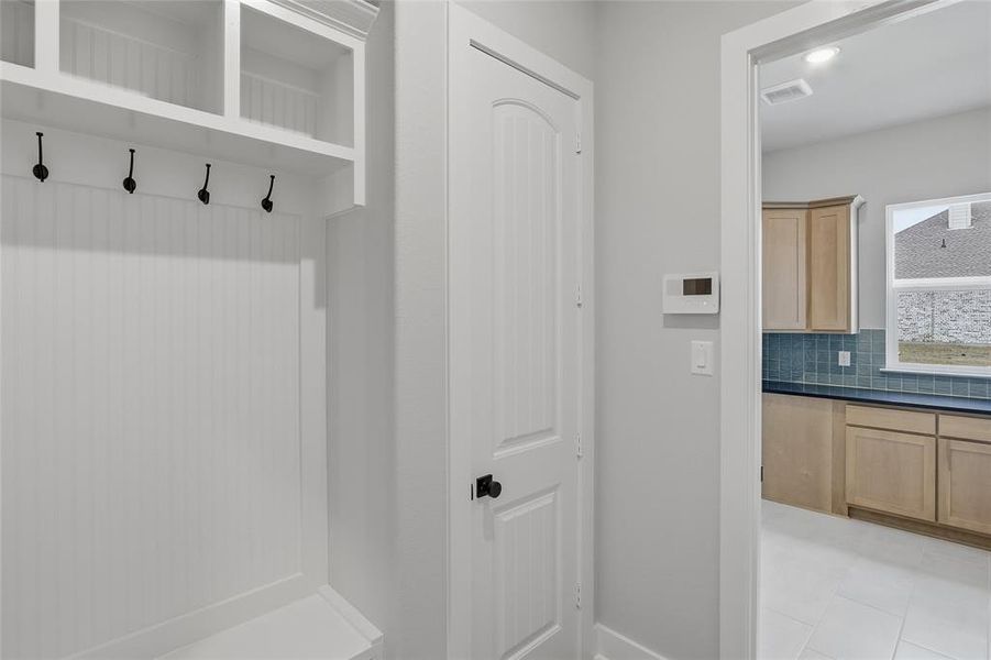 Mudroom with baseboards and recessed lighting
