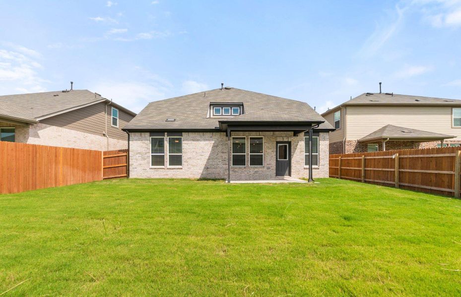 Front exterior of a new home in Lagos, Manor, TX, highlighting curb appeal (Image 16). Front exterior of a new home in Lagos, Manor, TX, highlighting curb appeal (Image 16).