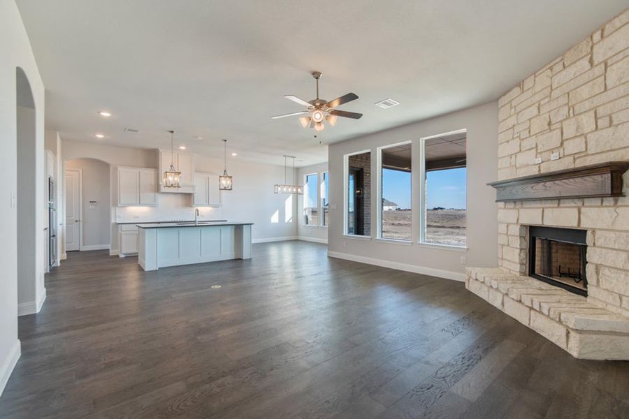 Family Room to Kitchen | Concept 2406 at The Meadows in Gunter, TX by Landsea Homes