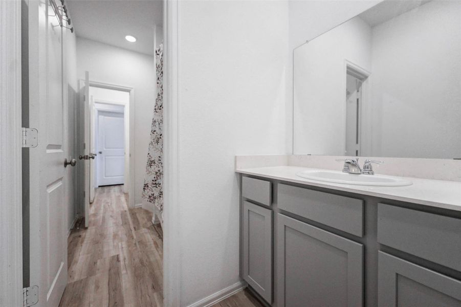 Modern "Jack N Jill" Bath with stylish finishes and ample cabinet storage. Serves secondary bedrooms in this 4-bedroom Katy ISD home. Modern "Jack N Jill" Bath with stylish finishes and ample cabinet storage. Serves secondary bedrooms in this 4-bedroom Katy ISD home.