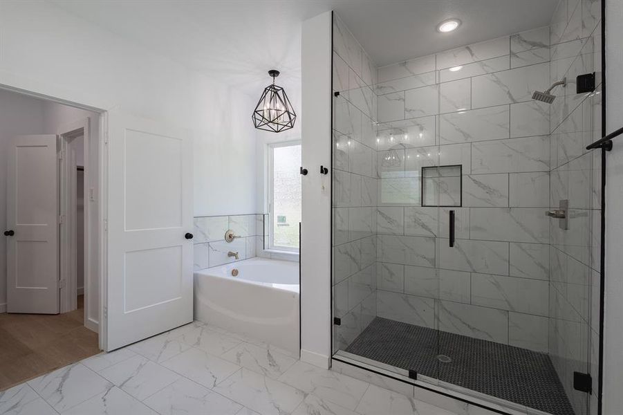Bathroom with a bath, a shower stall, marble finish flooring, and recessed lighting Bathroom with a bath, a shower stall, marble finish flooring, and recessed lighting