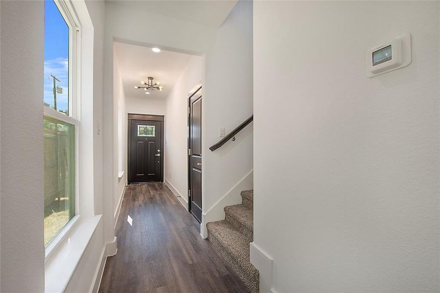 Corridor featuring dark wood-type flooring